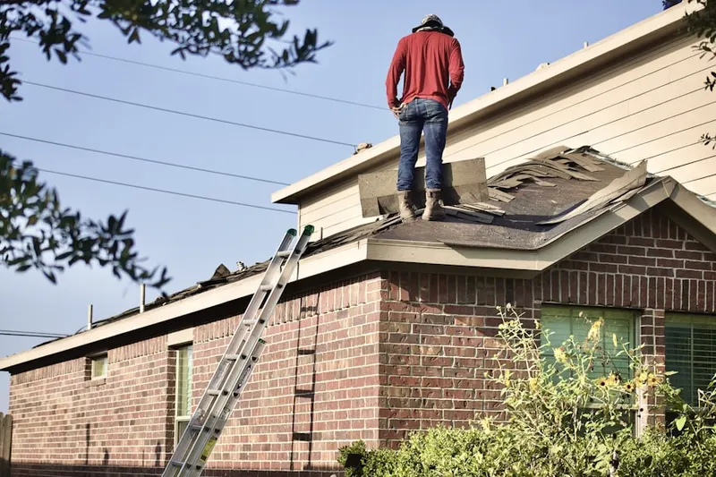 Professional roofer working on a residential roof in Ashburn Farm